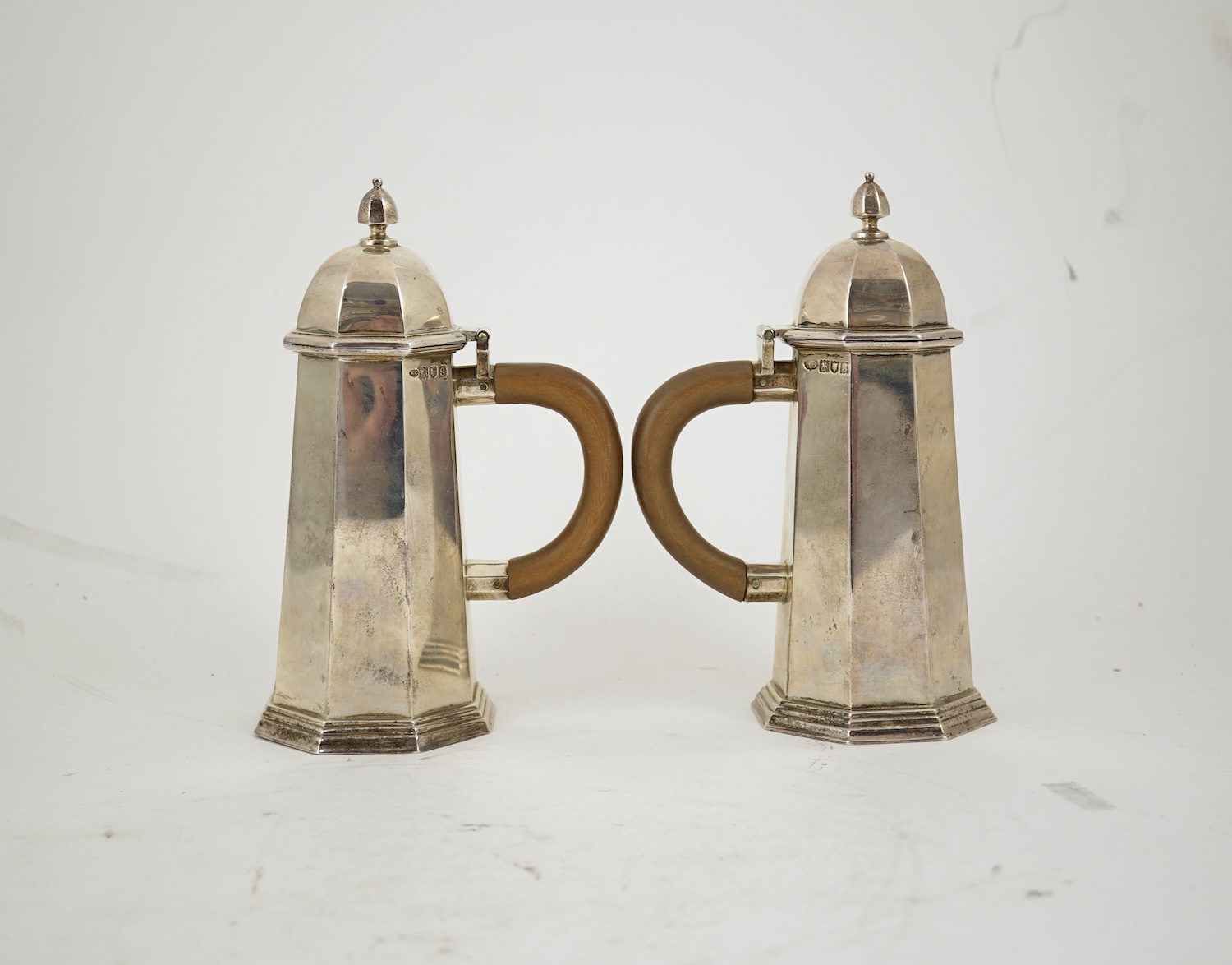 A pair of George V octagonal silver café au lait pots, by William Comyns & Sons Ltd